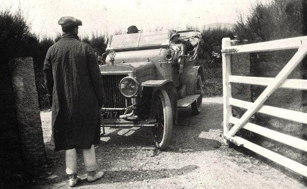 William Rhodes-Moorhouse arriving, possibly in a Daimler, the person meeting him may be Jack Tookey, his chief mechanic, 1913