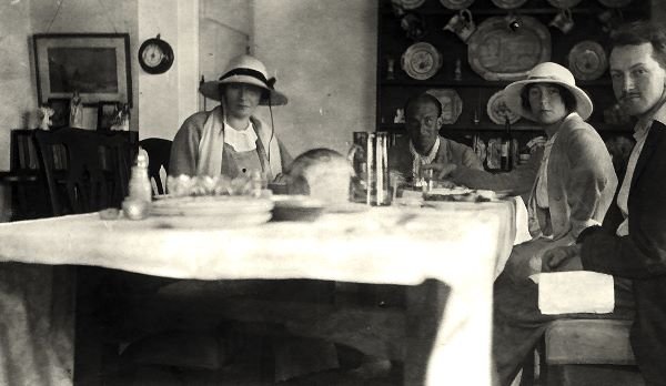 Linda Rhodes-Moorhouse is the lady on the right, sitting in the kitchen with guests, 1913. The Rhodes-Moorhouse family built their own house next door in 1925.